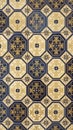 Traditional octagonal and square ceramic tiles with ornate blue and gold floral patterns on a cream background Royalty Free Stock Photo
