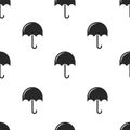Repeating seamless pattern of black umbrellas on a white background, minimalistic graphics for print fabric, wrapping paper or Royalty Free Stock Photo