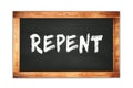 REPENT text written on wooden frame school blackboard