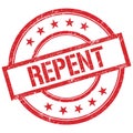 REPENT text written on red vintage stamp