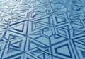 A repetitive geometric pattern covering a surface, featuring three-dimensional triangles and Royalty Free Stock Photo