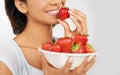 Replace that bowl of ice cream with this instead. a young woman enjoying a bowl of strawberries. Royalty Free Stock Photo
