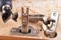 Replacement and assembly of furniture hinges. Small carpentry work in the home workshop