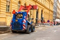 Replacement of curbs and repair of sidewalks in the old city. Workers change the curb with the help of a tractor