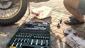 Replacement of lubricating oil in a motorcycle. man drains dirty waste oil from a motorcycle.