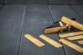 Replacement reeds and saxophone mouthpiece with clamp and golden adjustment screws on gray wooden table Royalty Free Stock Photo