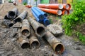 Replacement of water supply and sewer pipes, dirty old pipes next to new modern plastic pipes