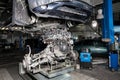 Replacement used engine on a table mounted under raised car on lift  for installation after a breakdown and repair in a vehicle Royalty Free Stock Photo