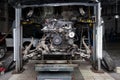 Replacement used engine on a table mounted under raised car on lift  for installation after a breakdown and repair in a vehicle Royalty Free Stock Photo