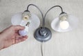 Replacing electric lightbulbs in household wall lamp, LED light bulb