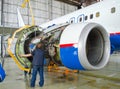 Replacing the engine on the plane, working people tap. Concept maintenance of aircraft.