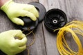 Replacing  line in the head of the grass trimmer, hands in gloves Royalty Free Stock Photo