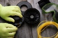 Replacing  line in the head of the grass trimmer, hands in gloves close-up Royalty Free Stock Photo