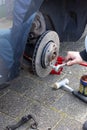 Replacing an old brake disc for a new brake disc by a mechanic