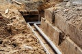 Replacing the old pipeline. Trench with replaced metal pipes and concrete base. Selective focus