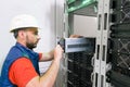 . Replacing the power module in the server room rack. Maintenance of data center equipment. The technician installs a new battery