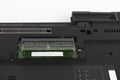 Replacing of ram memory in laptop computer. Underside of the notebook on white