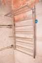 Replacing and relocating a heated towel rail with hot water in the bathroom