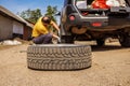 Replacing a spare wheel on the road with your own hands. The driver changes the wheel without the help of an auto repair Royalty Free Stock Photo