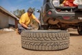 Replacing a spare wheel on the road with your own hands. The driver changes the wheel without the help of an auto repair Royalty Free Stock Photo