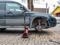 Replacing the wheel on the tire service center. Car without a wheel lifted on the jack