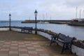 A Replica cast iron gas street lamp on the seated pavement area outside the famous Cockle Row Irish cottages at Groomsport Harbour Royalty Free Stock Photo