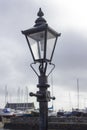 A Replica cast iron gas street lamp on the seated pavement area outside the famous Cockle Row Irish cottages at Groomsport Harbour Royalty Free Stock Photo