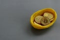 Replica of golden bitcoin in a bird nest. Grey background. Copy space for text or logo.