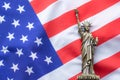 A replica of the Statue of liberty placed on the USA flag. There is Lighting on the side of the statue. 4th of July, Celebrate Royalty Free Stock Photo