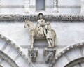 Replica statue of Saint Martin and the Beggar on the facade of the Lucca Cathedral