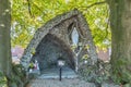 Replica of a statue of the Virgin of Lourdes praying on a rock with a rosary Royalty Free Stock Photo