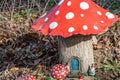 Replica of a wooden elf house in middle of Dutch forest, mushroom shape with two goblins at door Royalty Free Stock Photo