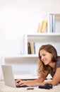 Replying to some emails. a young woman using her laptop at home. Royalty Free Stock Photo