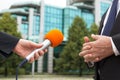 Reporter holding microphone interviewing businessman or politician Royalty Free Stock Photo