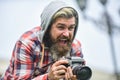 Reporter make photo. vintage camera. capture these memories. SLR camera. hipster man with beard use professional camera Royalty Free Stock Photo