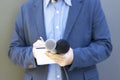 Journalist at media event or news conference, holding microphone, writing notes. Broadcast journalism concept. Royalty Free Stock Photo