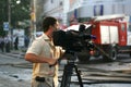 The reporter reports on the fire in the building from the scene Royalty Free Stock Photo