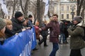 Reporter of the Russian TV Rain channel Aleksei Korostelev interviewing demonstrators carrying a political banner