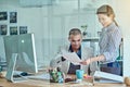 These reports are looking good. two businesspeople looking through some paperwork in an office. Royalty Free Stock Photo