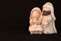 Representation of a Christmas nativity scene with the figures of baby Jesus, Mary and Joseph on a rock background. Phrase space on Royalty Free Stock Photo