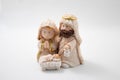 Representation of a Christmas nativity scene with the figures of baby Jesus, Mary and Joseph on a white Background. Christmas Royalty Free Stock Photo