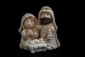 Representation of a Christmas nativity scene with the figures of baby Jesus, Mary and Joseph on a black background. Christmas Royalty Free Stock Photo