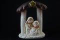 Representation of a Christmas nativity scene with the figures of baby Jesus, Mary and Joseph on a black background. Christmas Royalty Free Stock Photo