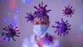 Representation of the covid-19 virus or coronavirus, blue, purple, pink spheres, with growths, with a masked face in the backgrou