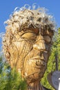 representation of a large human head made from pieces of tree bark