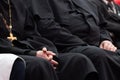 Representatives of the Orthodox clergy in black robes sit in the conference hall. Meeting clerics and priests. Conceptual