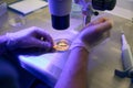 Reproductology laboratory technician taking liquid from test tube with pipette