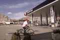 Repsol Petrol station with senior cyclist crossing