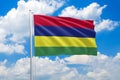 Mauritius national flag waving in the wind on clouds sky. High quality fabric. International relations concept