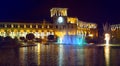 Republic Square at night in Yerevan. Clock tower. A fountain with colored lights and a building illuminated by lights.
